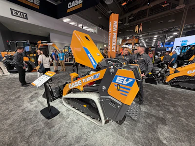 CASE TL100 EV compact track loader displayed at construction equipment trade show with visitors