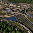 Aerial view of a complex multi-level highway interchange with elevated roads, water channels, and surrounding green forest and residential areas