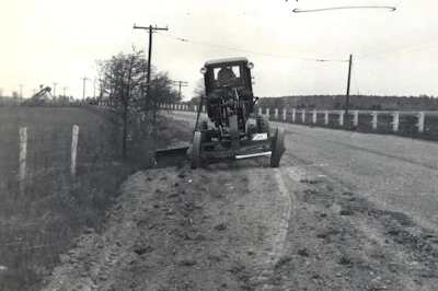 A Maryland State Roads Commission road grader in the 1940s performing shoulder work on MD 451. The original course of MD 451 is now the portion of MD 33 between Claiborne and Tilghman Island. MD 451 was removed from the state highway system in 1998.
