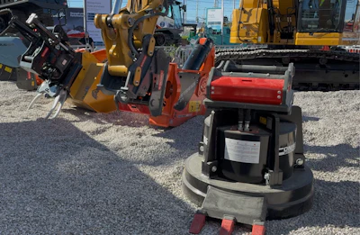 During this demonstration at ConExpo 2026, an excavator equipped with OilQuick switches among the lined-up attachments.