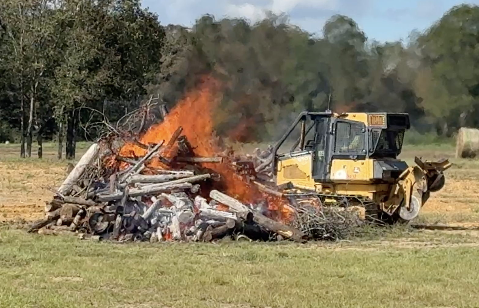 The Alabama Forestry Commission operates a dozer with NASA's new thermal sensor next to a test fire in September at the distance the dozers normally operate on a fire line. The thermal sensors performed as planned and have since been deployed on active wildfires.