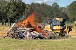 The Alabama Forestry Commission operates a dozer with NASA's new thermal sensor next to a test fire in September at the distance the dozers normally operate on a fire line. The thermal sensors performed as planned and have since been deployed on active wildfires.