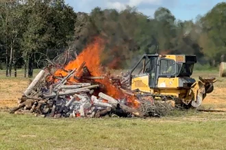 The Alabama Forestry Commission operates a dozer with NASA's new thermal sensor next to a test fire in September at the distance the dozers normally operate on a fire line. The thermal sensors performed as planned and have since been deployed on active wildfires.