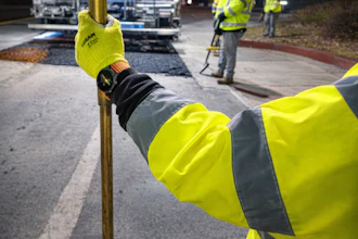 A worker seen wearing a Samsung Galaxy Watch, which delivers real-time traffic safety alerts via the RoadDefender system.
