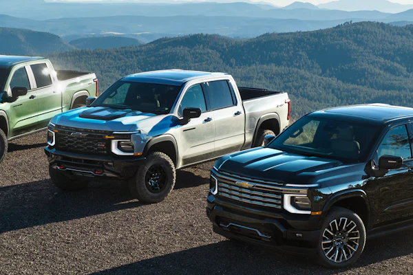 From left, 2027 Chevrolet Silverado 1500 Trail Boss in Trillium Metallic, ZR2 in White Sands and High Country in Black.