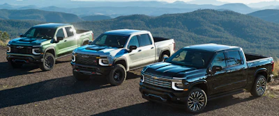 From left, 2027 Chevrolet Silverado 1500 Trail Boss in Trillium Metallic, ZR2 in White Sands and High Country in Black.