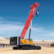 Red and yellow SANY mobile crane with extended boom lifting equipment at construction site