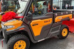 Orange and brown SDLG utility vehicle with red decorative bow at outdoor promotional event