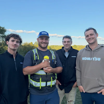 Sue is held by her rescuer Chase Guello with the River Reach Construction team.