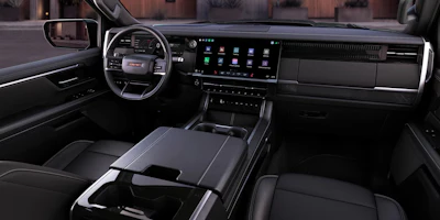 Modern GMC truck interior dashboard with digital display, leather seats, and steering wheel