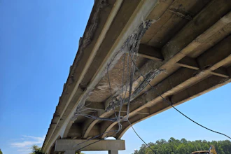 The damaged CR-87 bridge after being struck August 25 by an excavator being hauled on I-65 in Shelby County, Alabama.