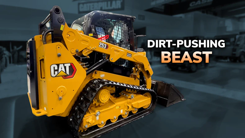 Yellow Caterpillar 289D compact track loader with marketing text 'Dirt-Pushing Beast' in industrial warehouse setting