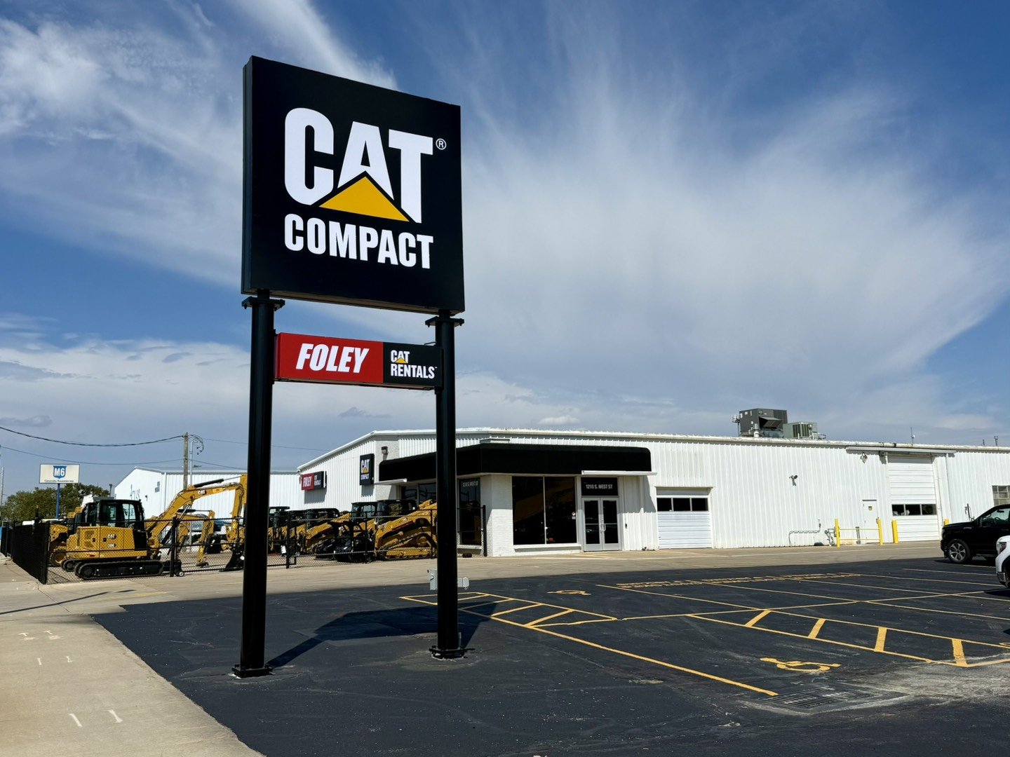 CAT Compact and Foley Equipment Rentals storefront with yellow construction equipment in parking lot