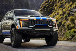 2026 Shelby Ford F-150 Baja Raptor R pickup truck with white and blue racing stripes on forest road