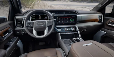 GMC truck interior dashboard with leather seats, digital display, and steering wheel controls