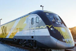 Brightline passenger train with yellow and white livery at sunset