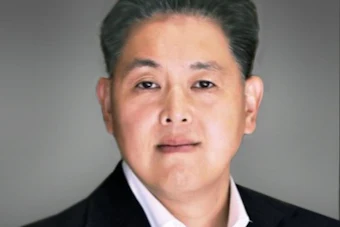 Edward Song new president Doosan Bobcat North America in business attire with dark blazer and white shirt