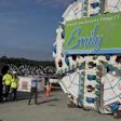 Tunnel boring machine with Emily Clean Rivers Project branding at construction site with workers