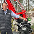 Man in Weidemann vest posing with red X07 wheel loader in forest setting