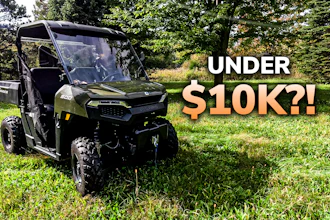 Olive green Polaris Ranger UTV parked on grass with pricing text 'Under $10K?!' overlaid, surrounded by trees
