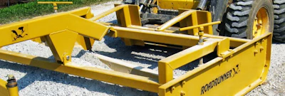 Yellow Roadrunner road equipment with black frame and tires in outdoor storage area