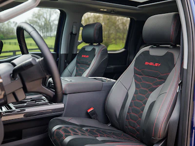 Shelby-branded black and red truck interior seats with steering wheel and dashboard visible