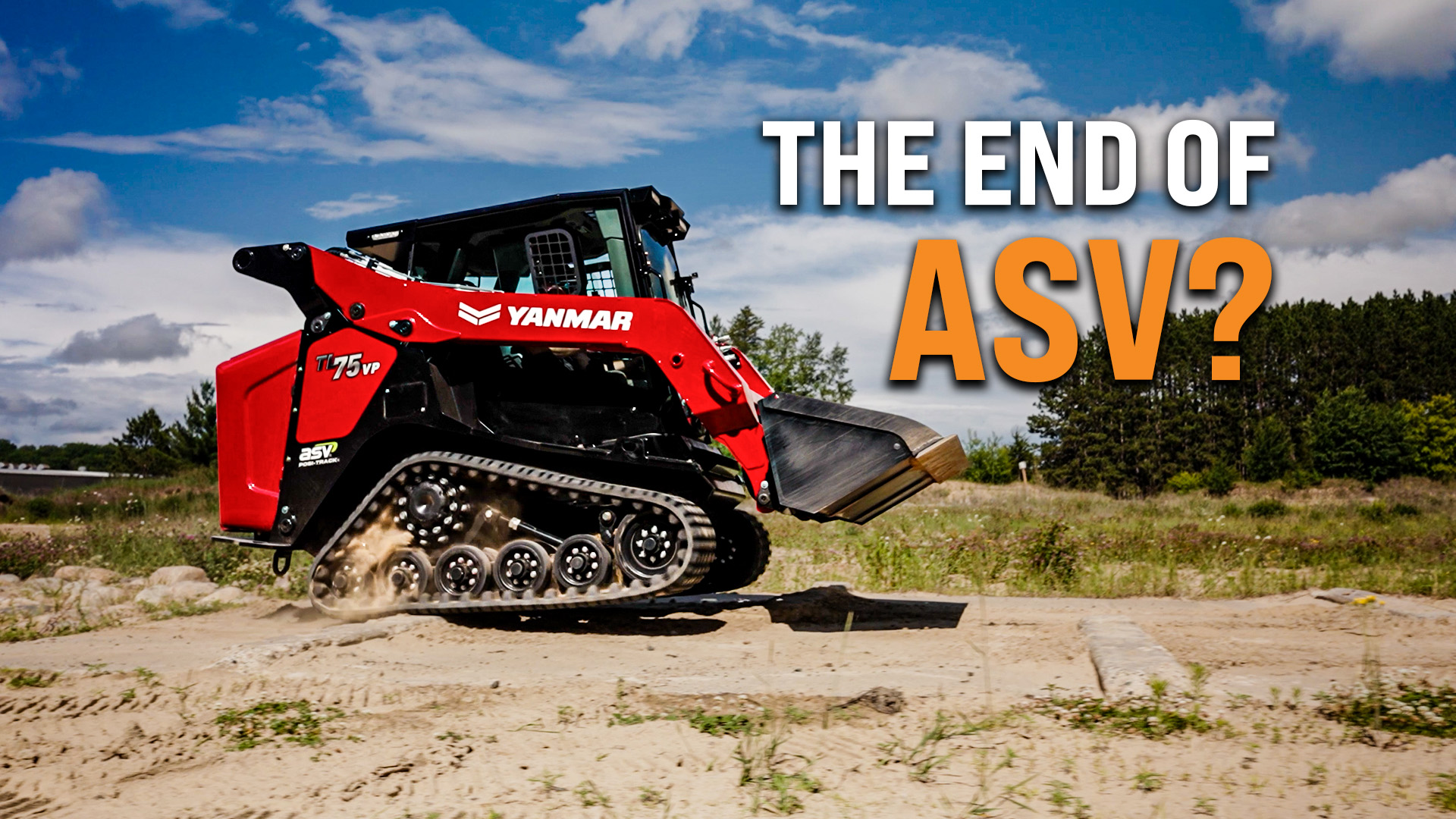 Red Yanmar compact track loader with rubber tracks on sandy terrain under blue sky