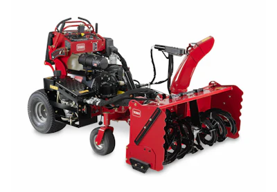 Toro red snow blower attachment mounted on riding mower with chute and auger system